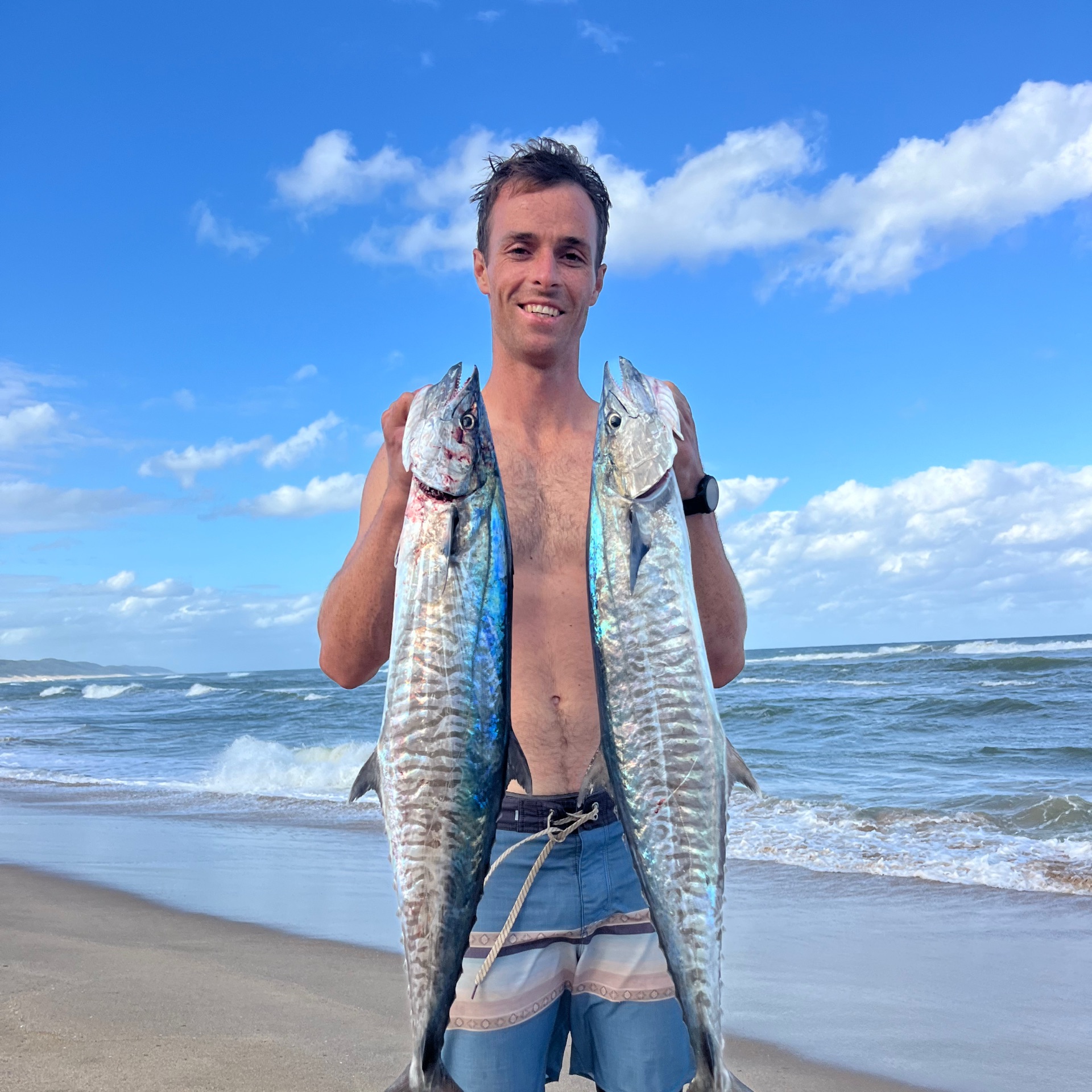 Justin Flemmer on the beach with a catch